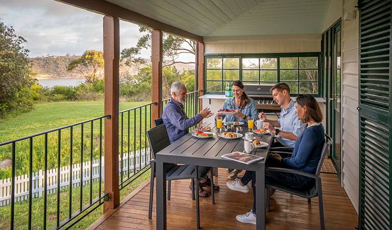 A group of friends having breakfast on the verandah at Middle Head Officers Quarters, Sydney Harbour National Park. Photo: John Spencer/DPIE